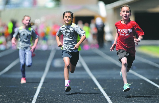 Pocatello Track Club’s Jade Huerta, center, tries to catch Rexburg Track Club’s Nicole Hipps, right, during the girls 10 and under 100 meter dash at the youth track club tri-meet on Thursday at Ravsten Stadium. Hipps finished first in her heat with Huerta taking second place. Pat Sutphin / psutphin@postregister.com